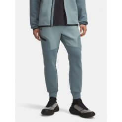 Spodnie Dresowe Męskie Under Armour. Niebieskie spodnie dresowe męskie Under Armour, bez wzorów, z dresówki. Za 199.99 zł.