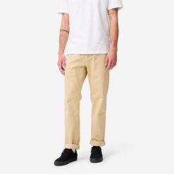 Spodnie chinos na deskorolkę CN500 Heavy beżowe. Brązowe eleganckie spodnie męskie Decathlon, bez wzorów, z bawełny, sportowe. Za 159.99 zł.