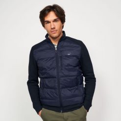 Kurtka do golfa męska ciepła CW900 hybrydowa. Niebieskie kurtki męskie INESIS, l, bez wzorów, z dzianiny, eleganckie, bez ramiączek, bez kaptura. Za 179.99 zł.