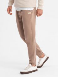 Klasyczne spodnie dresowe unisex ze ściągaczami brązowe V16 OU-PSBC-0100 M/L. Brązowe długie spodnie sportowe męskie Ombre, bez wzorów, z dresówki. Za 302.57 zł.