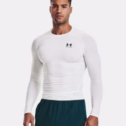 Koszulka fitness męska Under Armour Ua Hg Armour Comp LS z długim rękawem. Białe koszulki męskie z długim rękawem Under Armour, m, bez wzorów, sportowe, bez kołnierzyka, bez ramiączek. Za 228.77 zł.