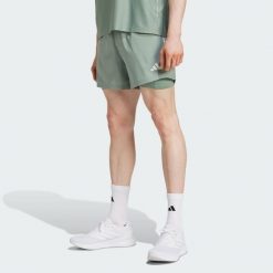 Szorty Own the Run CLIMACOOL 2-in-1. Zielone szorty sportowe męskie ADIDAS, bez wzorów, sportowe. Za 191.50 zł.
