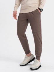 Spodnie męskie dresowe z przeszyciem i zamkiem na nogawce - brązowe V4 - Rozmiar: XXL. Brązowe spodnie dresowe męskie Ombre Clothing, bez wzorów, z bawełny. W wyprzedaży za 69.99 zł.