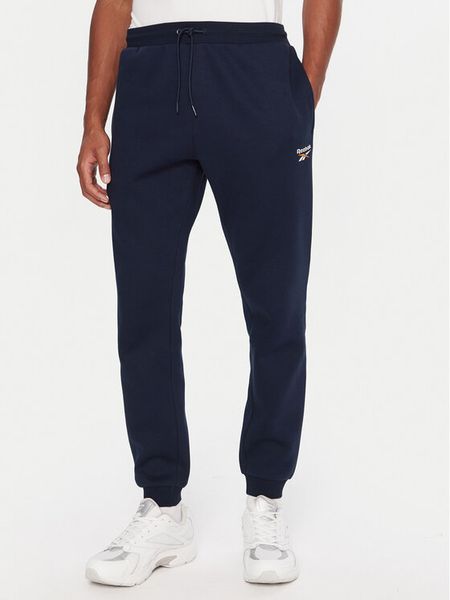 Reebok Spodnie dresowe RK25146CCM Granatowy Regular Fit. Niebieskie spodnie dresowe męskie Reebok, bez wzorów, z bawełny. Za 199.99 zł.
