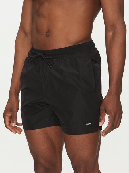 Calvin Klein Swimwear Szorty kąpielowe KM0KM01111 Czarny Regular Fit. Czarne kąpielówki męskie Calvin Klein Swimwear, bez wzorów, z syntetyku. Za 159.99 zł.