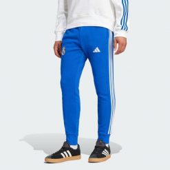 Spodnie Real Madrid DNA. Niebieskie spodnie dresowe męskie ADIDAS, bez wzorów, z dresówki. Za 300.00 zł.
