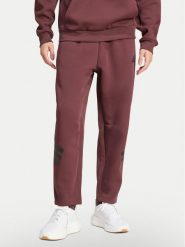 Adidas Spodnie dresowe Future Icons 3-Stripes JD4888 Bordowy Loose Fit. Czerwone spodnie dresowe męskie ADIDAS, bez wzorów, z bawełny. Za 259.99 zł.