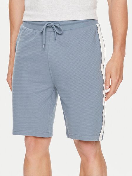 Tommy Hilfiger Szorty sportowe UM0UM03008 Niebieski Regular Fit. Niebieskie szorty sportowe męskie Tommy Hilfiger, bez wzorów, z bawełny, sportowe. Za 179.99 zł.