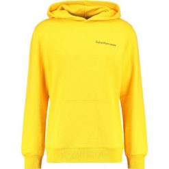 Calvin Klein Jeans HOROS 2 REGULAR POPOVER Bluza z kapturem spectra yellow. Bluzy nierozpinane męskie Calvin Klein Jeans. Za 499.00 zł.