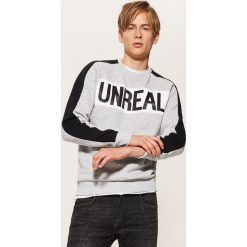 Bluza z napisem Unreal - Szary. Bluzy nierozpinane męskie marki DOMYOS. W wyprzedaży za 49.99 zł.