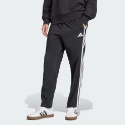 Spodnie Essentials 3-Stripes Stanford Open Hem. Białe długie spodnie sportowe męskie ADIDAS, bez wzorów, z materiału, na fitness i siłownię. W wyprzedaży za 143.20 zł.