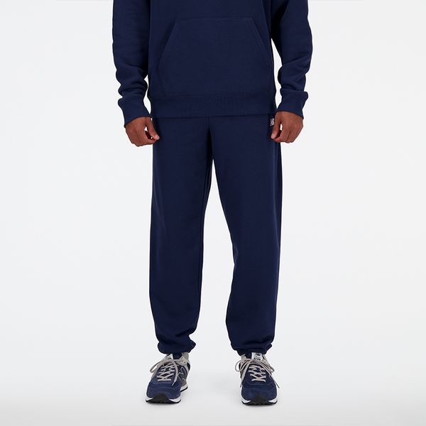 Spodnie męskie New Balance MP41519NNY – granatowe. Niebieskie spodnie dresowe męskie New Balance, bez wzorów, z bawełny. Za 249.99 zł.