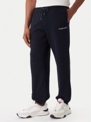 Guess Jeans Spodnie dresowe M6RB70 KCPR1 Granatowy Regular Fit. Niebieskie spodnie dresowe męskie Guess Jeans, z aplikacjami, z bawełny. Za 299.99 zł.