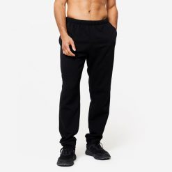 Spodnie dresowe męskie Domyos Gym & Pilates 100. Czarne spodnie dresowe męskie DOMYOS, bez wzorów, z bawełny. Za 49.99 zł.