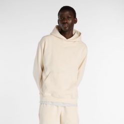 Bluza męska New Balance MT41534PEF – beżowa. Brązowe bluzy z kapturem męskie New Balance, l, bez wzorów, z materiału, z kapturem. Za 399.99 zł.