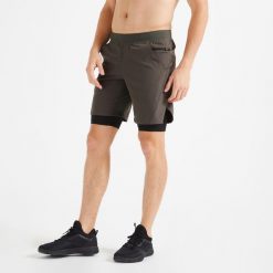 Spodenki fitness cardio męskie Domyos 2 w 1. Brązowe szorty sportowe męskie DOMYOS, bez wzorów, z elastanu, sportowe. W wyprzedaży za 69.99 zł.