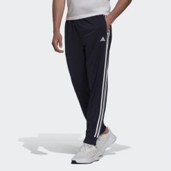 Primegreen Essentials Warm-Up Tapered 3-Stripes Track Pants. Białe spodnie dresowe męskie ADIDAS, bez wzorów, z dresówki. W wyprzedaży za 164.25 zł.