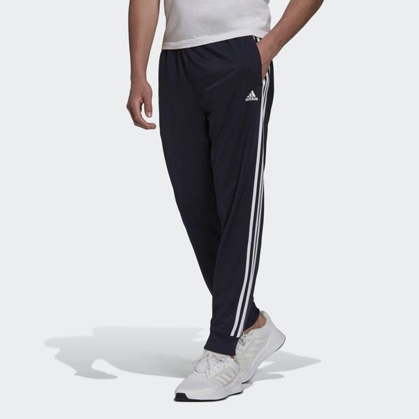 Primegreen Essentials Warm-Up Tapered 3-Stripes Track Pants. Białe spodnie dresowe męskie ADIDAS, bez wzorów, z dresówki. W wyprzedaży za 150.85 zł.