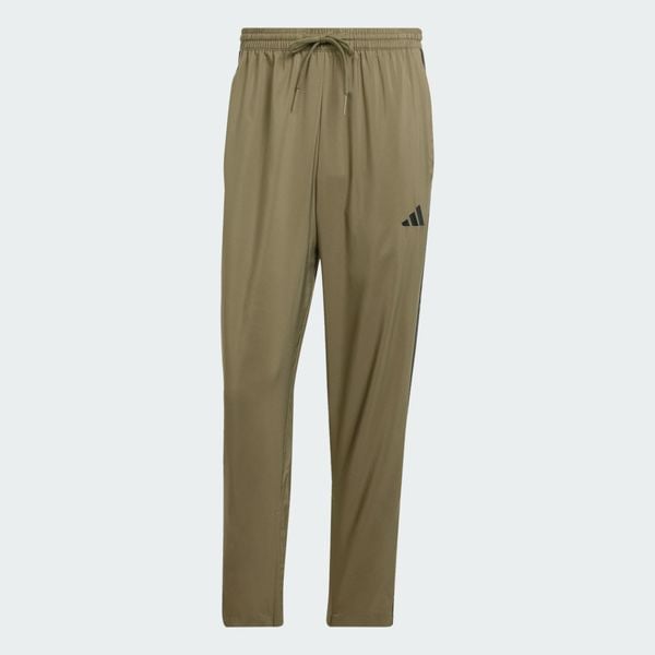 Spodnie Essentials 3-Stripes Stanford Open Hem. Brązowe długie spodnie sportowe męskie ADIDAS, bez wzorów, z materiału, na fitness i siłownię. Za 179.00 zł.