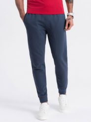 Spodnie męskie dresowe typu jogger - granatowe V4. Niebieskie spodnie dresowe męskie Ombre Clothing, bez wzorów, z bawełny. W wyprzedaży za 101.24 zł.