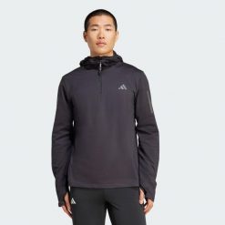 Bluza z kapturem Own The Run Winterized Hooded Half-Zip. Czarne bluzy z kapturem męskie ADIDAS, bez wzorów, bez zapięcia, do biegania, ClimaWarm (Adidas). Za 260.50 zł.