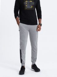 Spodnie męskie dresowe z przeszyciami - szary melanż V3. Szare spodnie dresowe męskie Ombre Clothing, bez wzorów, z bawełny. W wyprzedaży za 39.99 zł.