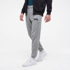 Spodnie dresowe męskie Puma Gym & Pilates. Szare spodnie dresowe męskie Puma, bez wzorów, z bawełny. W wyprzedaży za 129.99 zł.