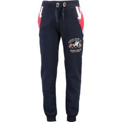Spodnie dresowe "Moduk" w kolorze granatowym. Niebieskie spodnie dresowe męskie marki Geographical Norway, z aplikacjami, z dresówki. W wyprzedaży za 117.95 zł.