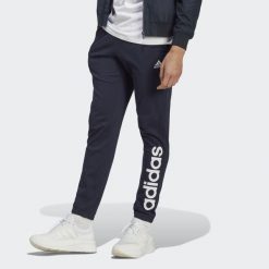 Spodnie dresowe męskie adidas Essentials Single Jersey Tapered Elasticized Cuff. Niebieskie długie spodnie sportowe męskie ADIDAS, bez wzorów, z dresówki. Za 157.99 zł.