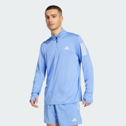 Bluza Own The Run Half-Zip. Niebieskie bluzy nierozpinane męskie ADIDAS, l, bez wzorów, z materiału, sportowe, bez ramiączek, bez kaptura. W wyprzedaży za 170.82 zł.