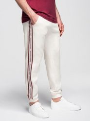 Sportowe spodnie męskie jogger z lampasami – kremowe V2. Białe długie spodnie sportowe męskie Ombre Clothing, bez wzorów, z bawełny. Za 219.99 zł.