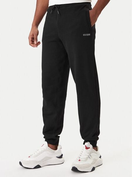 Guess Spodnie dresowe Z6RB12 KAIJ1 Czarny Regular Fit. Czarne spodnie dresowe męskie Guess, z aplikacjami, z bawełny. Za 299.99 zł.