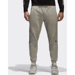 Adidas Spodnie męskie Zne Striker beżowe r. M (CW0140). Długie spodnie sportowe męskie ADIDAS. Za 248.70 zł.