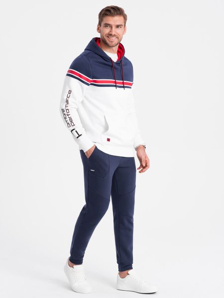 Spodnie męskie dresowe joggery - ciemnoniebieskie V4 - Rozmiar: M. Niebieskie spodnie dresowe męskie Ombre Clothing, bez wzorów, z bawełny. W wyprzedaży za 69.99 zł.