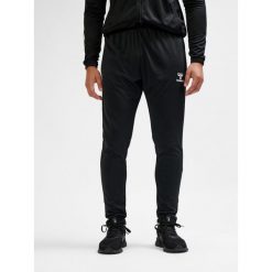 SPODNIE hmlESSENTIAL TRAINING PANTS. Czarne długie spodnie sportowe męskie HUMMEL, bez wzorów, z dresówki, do piłki nożnej. Za 150.00 zł.