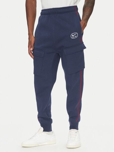 Nike Spodnie dresowe HM0180 Granatowy Regular Fit. Niebieskie spodnie dresowe męskie Nike, bez wzorów, z bawełny. Za 299.99 zł.