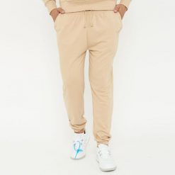 Spodnie sportowe unisex F BALLON beżowe. Brązowe długie spodnie sportowe męskie Legea, bez wzorów, z gumy, na fitness i siłownię. W wyprzedaży za 92.00 zł.