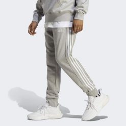 Spodnie dresowe męskie adidas Essentials French Terry Tapered Cuff 3-Stripes. Białe spodnie dresowe męskie ADIDAS, bez wzorów, z dresówki. Za 186.99 zł.