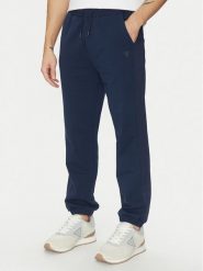 Guess Spodnie dresowe Z5GB06 K6ZS1 Granatowy Regular Fit. Niebieskie spodnie dresowe męskie Guess, z aplikacjami, z bawełny. Za 207.00 zł.