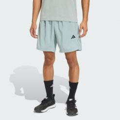 Tkane Szorty Do Ćwiczeń Essentials Base. Zielone szorty sportowe męskie ADIDAS, bez wzorów, sportowe. Za 119.00 zł.