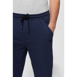 Spodnie dresowe męskie SPMD302 - granat melanż. Spodnie dresowe męskie marki 4f. Za 139.99 zł.