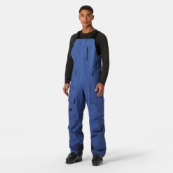 Spodnie narciarskie z szelkami i kieszenią cargo Helly Hansen Sogn. Niebieskie spodnie narciarskie i snowboardowe męskie Helly Hansen, bez wzorów, narciarskie. Za 1,037.00 zł.