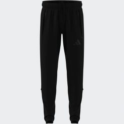 Spodnie piłkarskie ADIDAS Tiro Travel 26 treningowe. Długie spodnie sportowe męskie ADIDAS, bez wzorów, z dresówki. Za 289.99 zł.