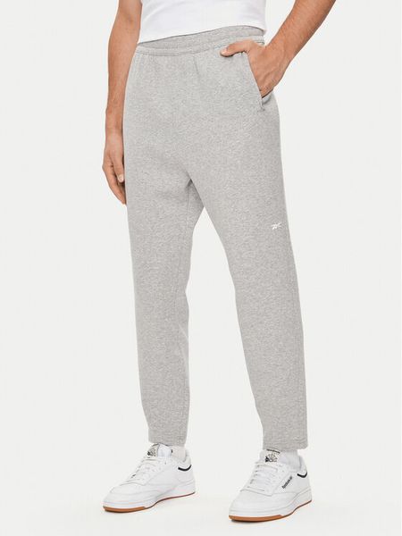 Reebok Spodnie dresowe Activ Coll Dreamblend 100075606 Szary Regular Fit. Szare spodnie dresowe męskie Reebok, bez wzorów, z bawełny. Za 209.99 zł.