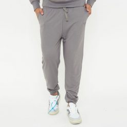 Spodnie sportowe unisex F BALLON szare. Szare długie spodnie sportowe męskie Legea, bez wzorów, z gumy, na fitness i siłownię. W wyprzedaży za 92.00 zł.