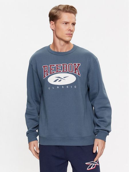 Reebok Bluza Archive Essentials IM1531 Niebieski Regular Fit. Niebieskie bluzy nierozpinane męskie Reebok, m, bez wzorów, z bawełny, bez ramiączek, bez kaptura. Za 179.99 zł.