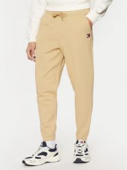 Tommy Jeans Spodnie dresowe Badge DM0DM20276 Beżowy Regular Fit. Brązowe spodnie dresowe męskie Tommy Jeans, bez wzorów, z bawełny. Za 199.99 zł.
