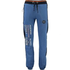 Spodnie dresowe "Mindwiller" w kolorze niebieskim. Niebieskie spodnie dresowe męskie marki Geographical Norway, z aplikacjami, z dresówki. W wyprzedaży za 117.95 zł.