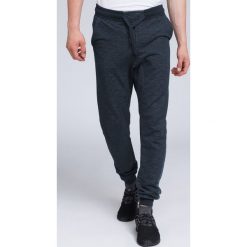 Spodnie dresowe męskie SPMD003 - denim melanż. Spodnie dresowe męskie marki 4f. W wyprzedaży za 129.99 zł.