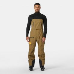 Kombinezon narciarski Helly Hansen Ridge Infinity. Brązowe spodnie narciarskie i snowboardowe męskie Helly Hansen, bez wzorów, narciarskie. W wyprzedaży za 2,201.50 zł.